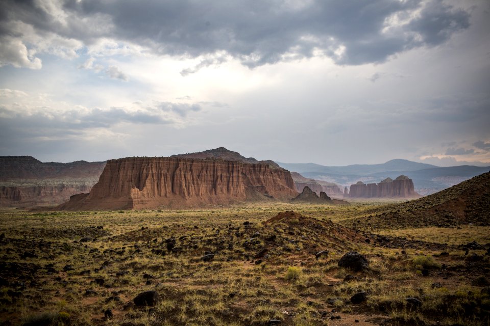 Scenic View Of Desert Landscape Against Dramatic Sky