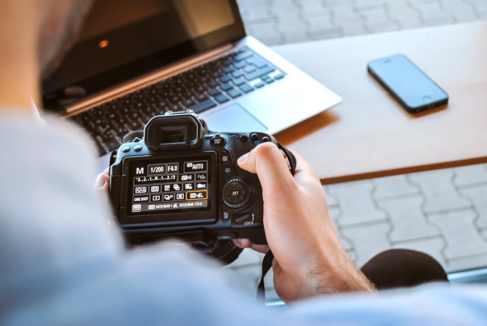 A Man Checking His Camera Settings