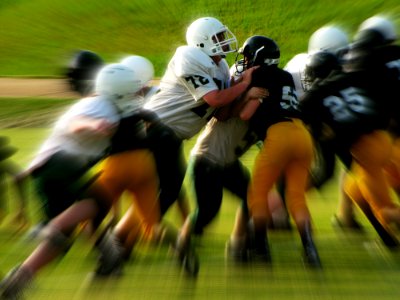 Men In White And Black Playing Football