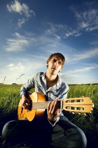 Man Playing Guitar On Field