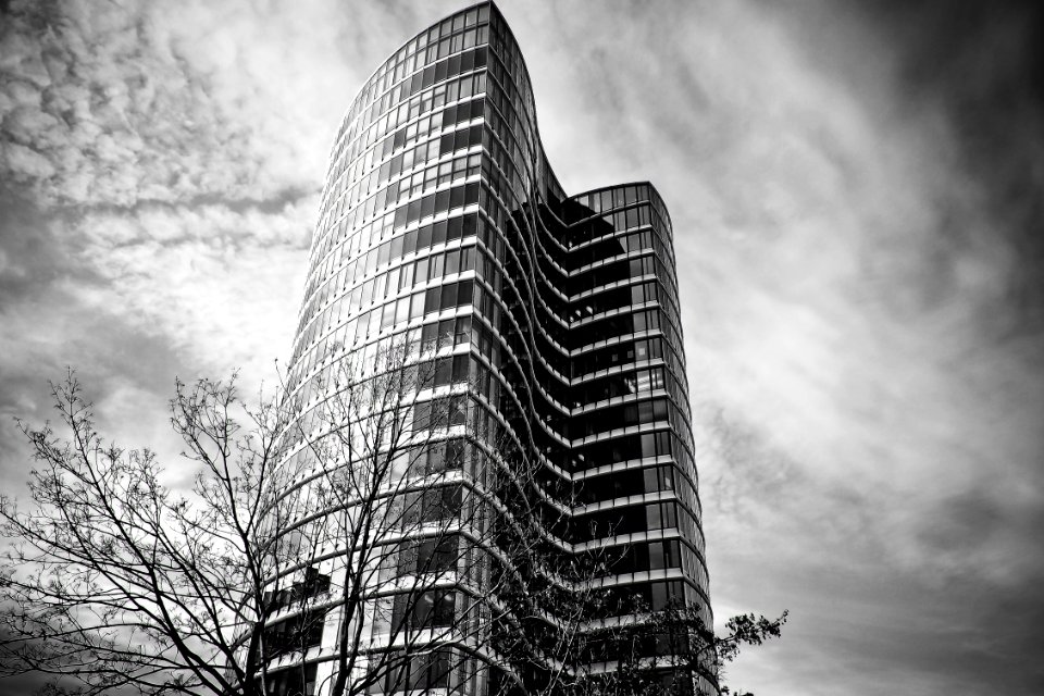 Low Angle View Of Skyscrapers Against Cloudy Sky photo