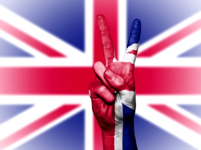 Hands With Peace Sign Against Union Jack photo