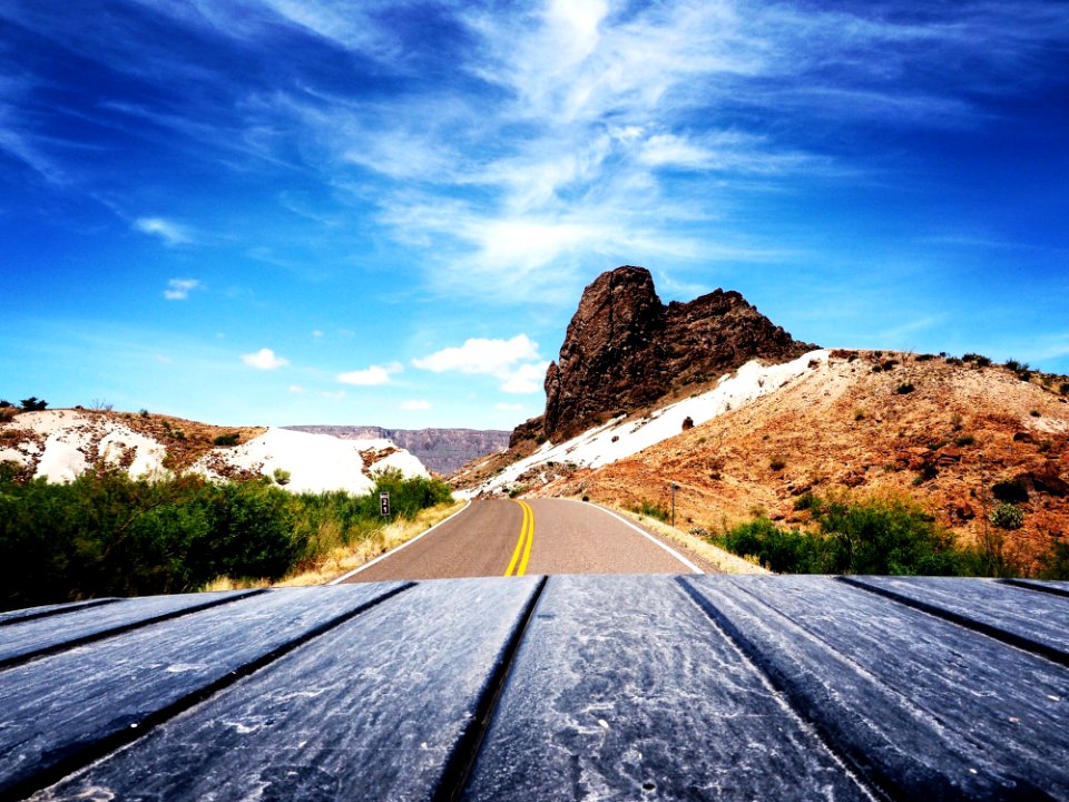 Scenic View Of Mountain Road Against Blue Sky