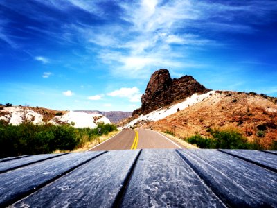 Scenic View Of Mountain Road Against Blue Sky photo