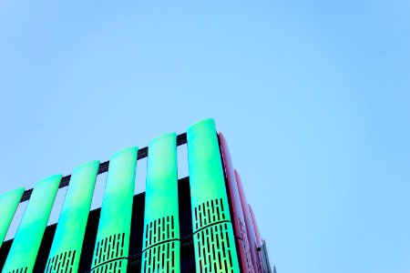 Modern Green Building Against Blue Skies