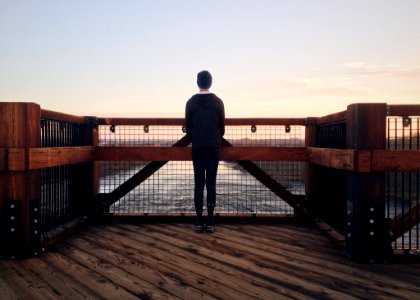 Rear View Of A Man Walking On Beach