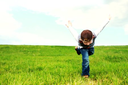Kid Running On Grass photo