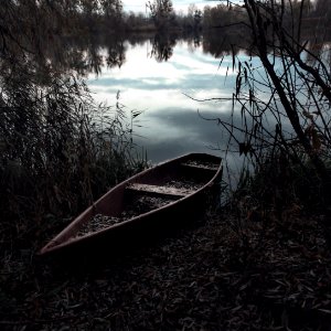 Wooden Canoe On River Banks photo