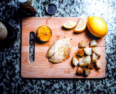 Fish And Potatoes On Cutting Board photo