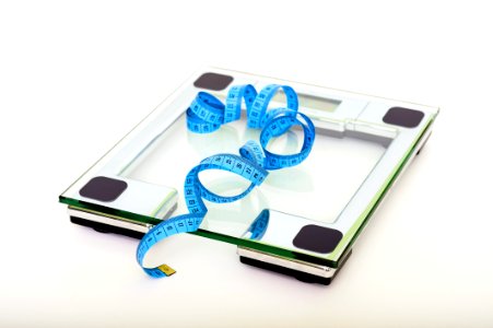 Blue Tape Measuring On Clear Glass Square Weighing Scale photo
