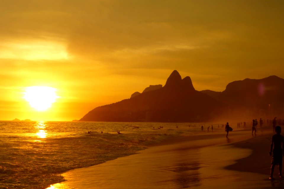 Group Of People On Seashore During Sunset