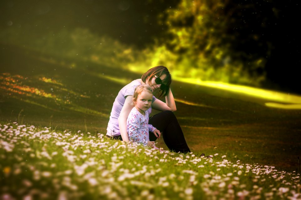 Mother And Daughter In Field Of Wildflowers