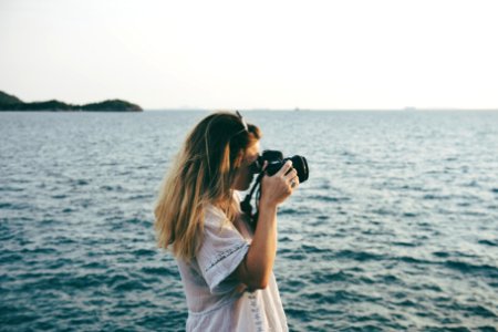 Woman On Beach Taking Photos photo