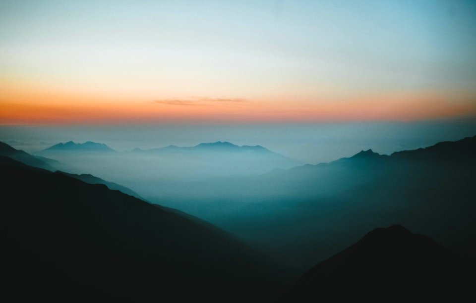 Mountain Peaks On A Foggy Day