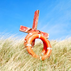 Life Buoys Tied To A Wooden Cross photo