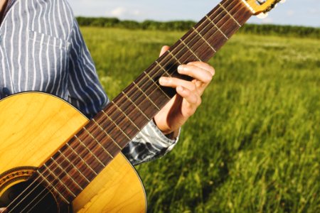 Man Playing Guitar On Field photo