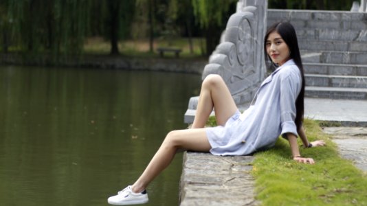 Woman Sitting Beside A Lake photo