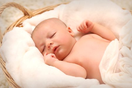 Baby Sleeping On White Cotton photo