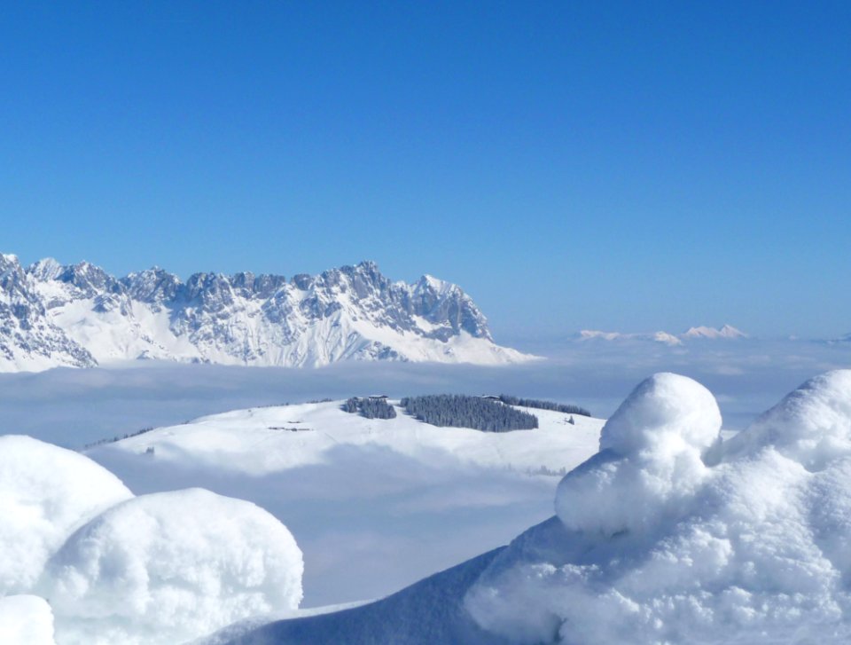 Scenic View Of Snow Mountains Against Blue Sky photo