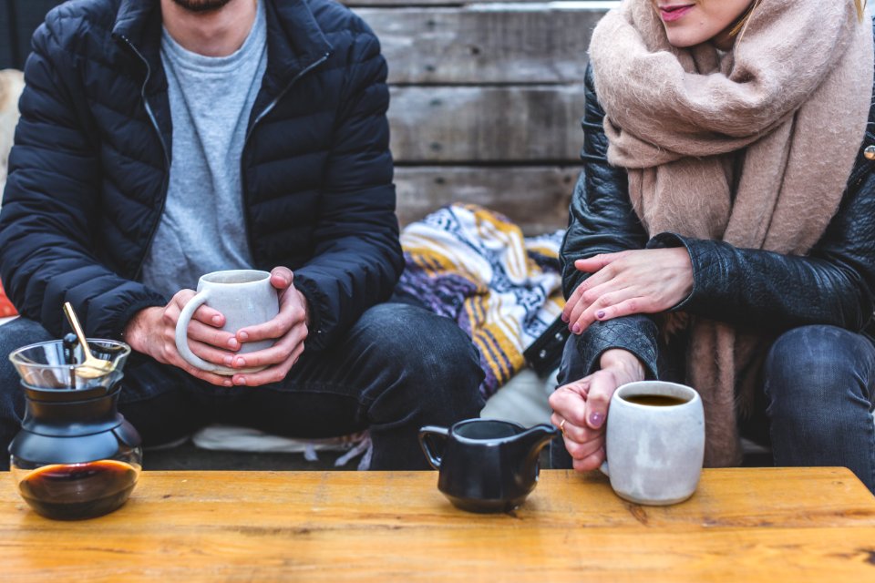 Man And Woman Having Coffee Outdoors