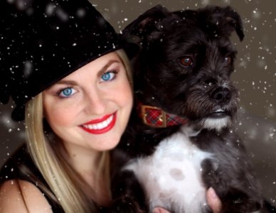 Portrait Of Smiling Woman With Dog In Winter