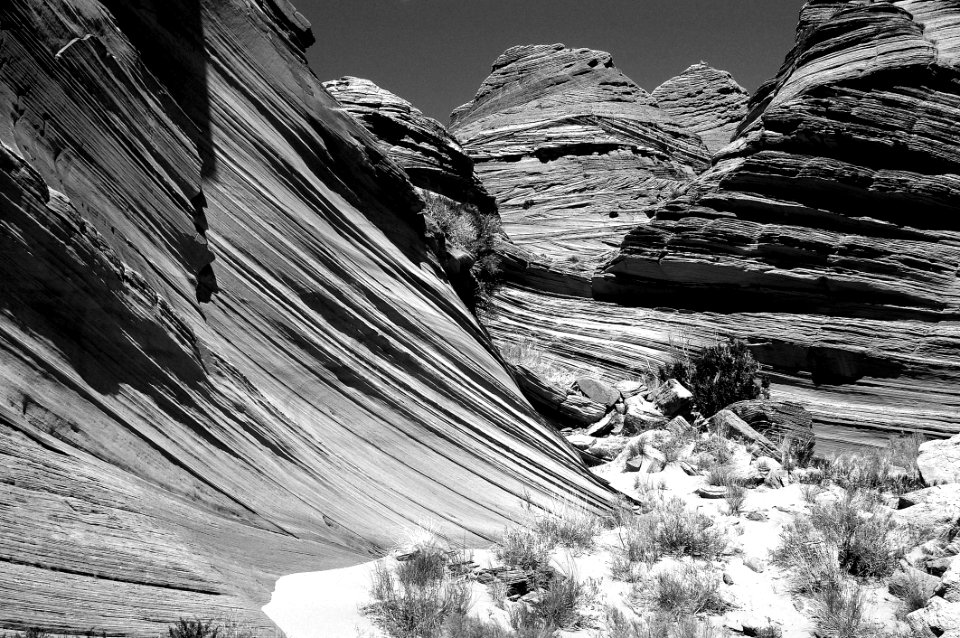 Grey Scale Photography Of Rocky Mountain Grass Fields