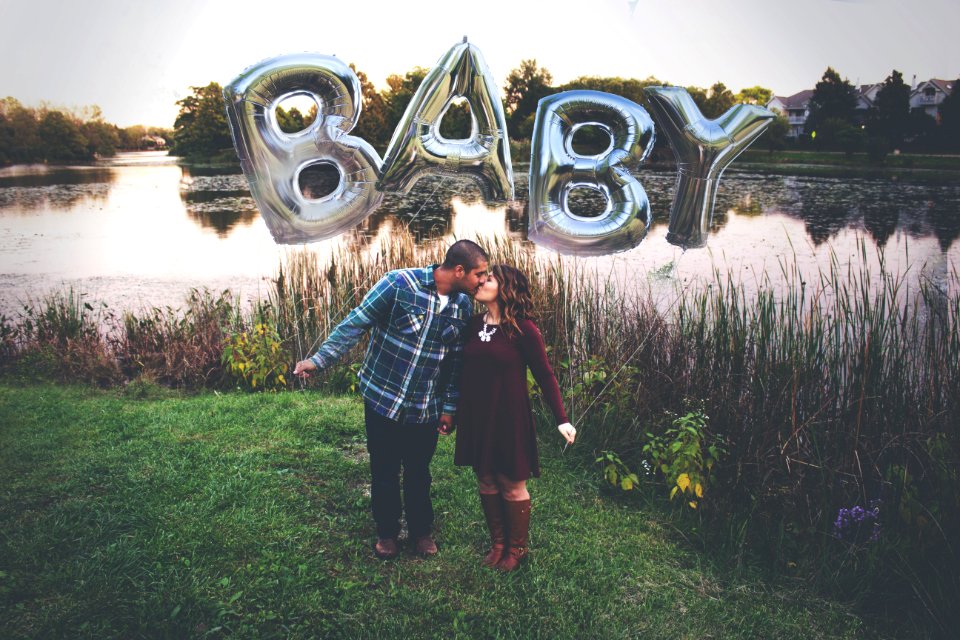 Couple Kissing Outdoors Beside A River