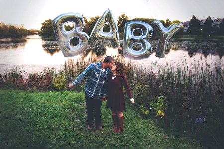 Couple Kissing Outdoors Beside A River