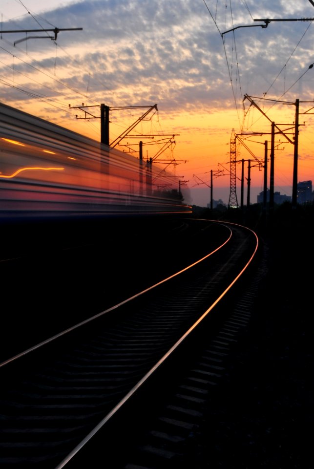 Rail Road Under Gray And Orange Cloudy Sky During Sunset
