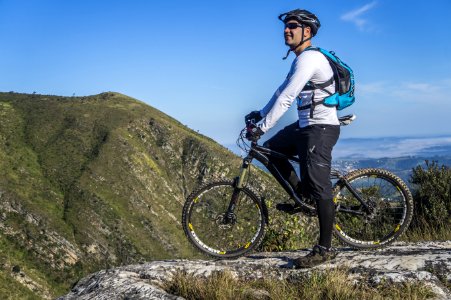 Man With White Shirt Riding Abicycle On A Mountain photo