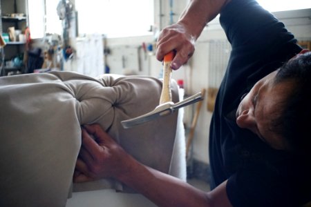 Man Putting On Upholstery