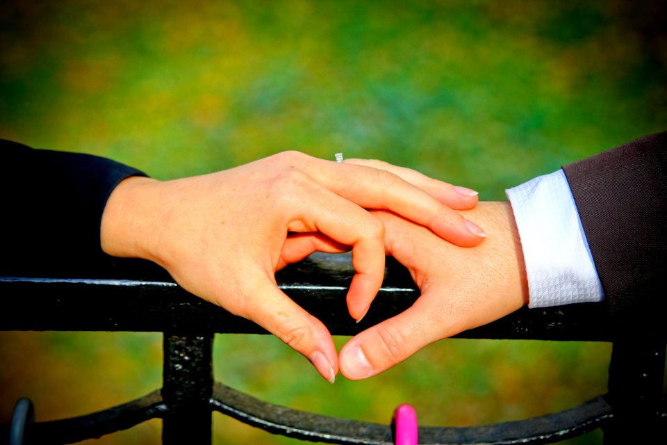 Couple Making A Heart Shape With Their Hands