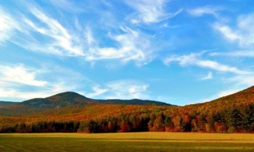 Autumn Foiliage Under Whispy Clouds At Grafton Notch Maine USA