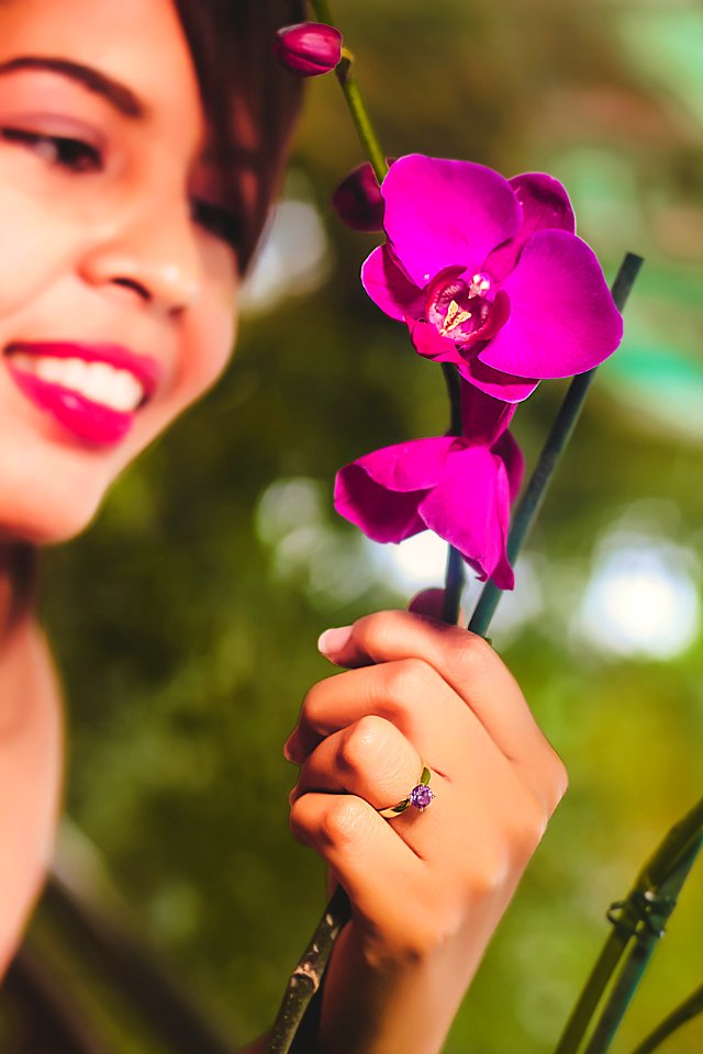 Woman Looking At Purple Orchids