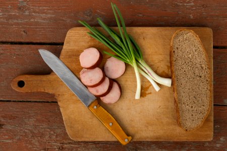 Kitchen Knife Next To Slice Bread On Chopping Board photo