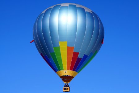 Hot Air Balloon Flying Against Blue Sky photo