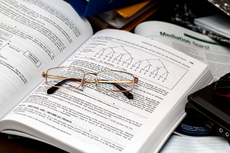 Textbook And Eyeglasses