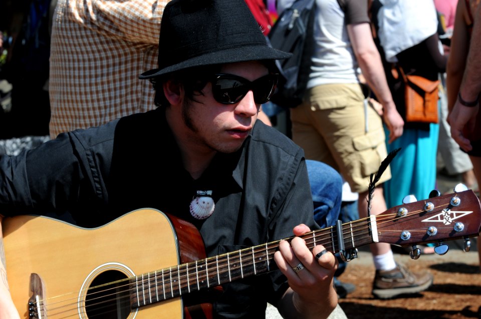 Street Performer With Sunglasses On Guitar