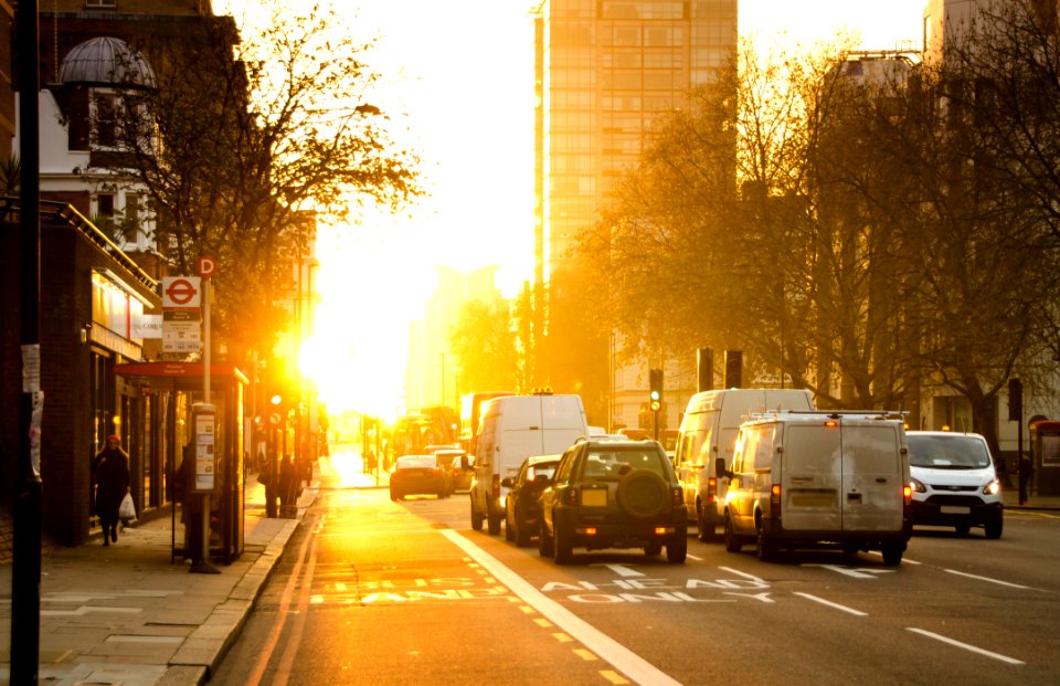 Black And White Vehicles Traveling On Gray Asphalt Road During Sunset photo