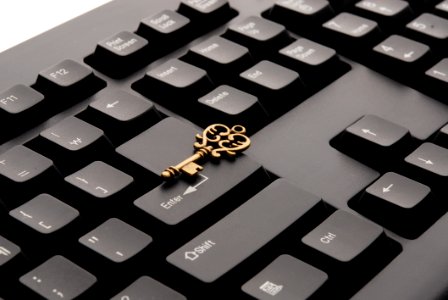 Brass Ornate Vintage Key On Black Computer Keyboard photo