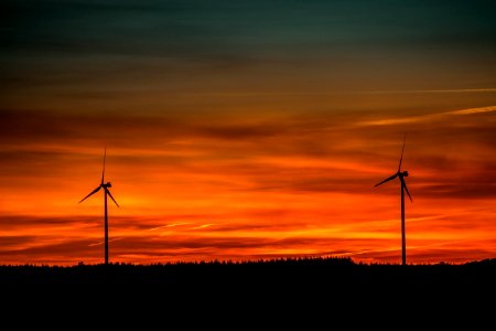 Silhouette Of Windmills Under Orange Sunset photo