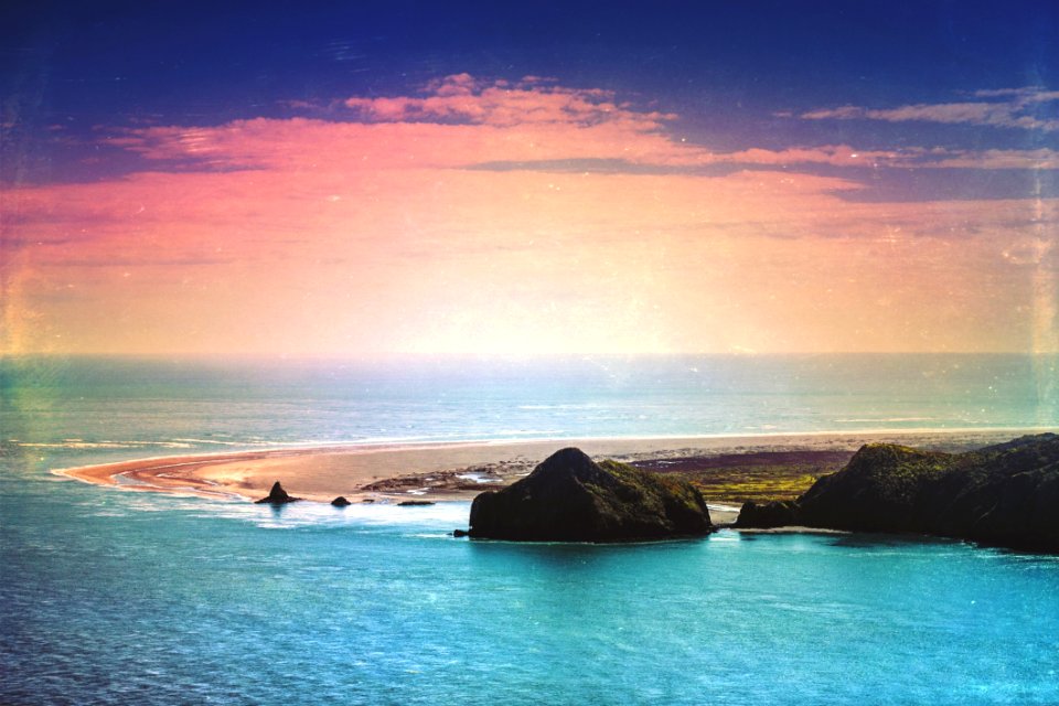 Green Island Surrounded By Blue Ocean Under Blue And Orange Sky