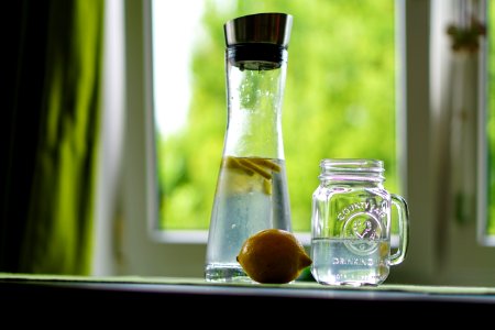 Shallow Focus Photography Of Yellow Lemon Near Glass Mason Jar And Glass Decanter