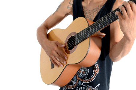 Person In Black Tank Top Playing Acoustic Guitar photo