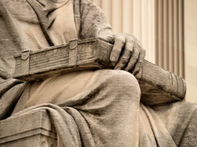 Closed Book With Clasps On The Lap Of Robert Ingersoll Aitkens Past On The North Side Of The National Archives