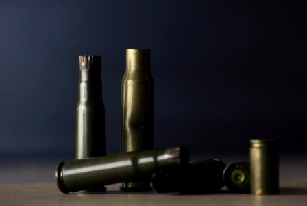 Empty Bullet Shells On Brown Surface photo