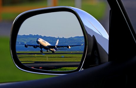 White Airplane Reflection On Car Side Mirror photo
