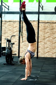 Athletic Woman Performing Handstand photo