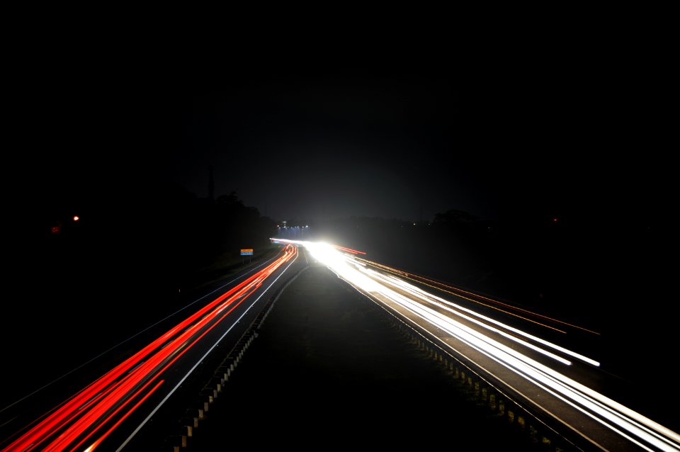 Motor Car Lights On Highway At Night