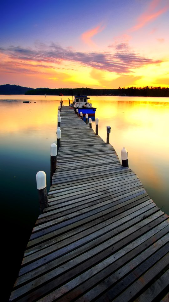 Boat Moored By Jetty At Sunset